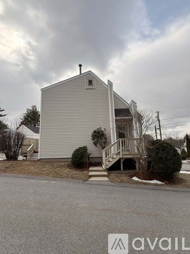 A house with a grey facade and a chimney is shown.