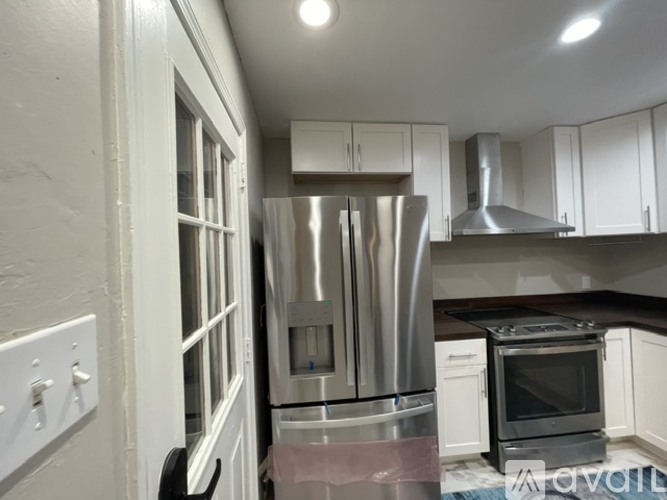 A kitchen with white cabinets and stainless steel appliances.