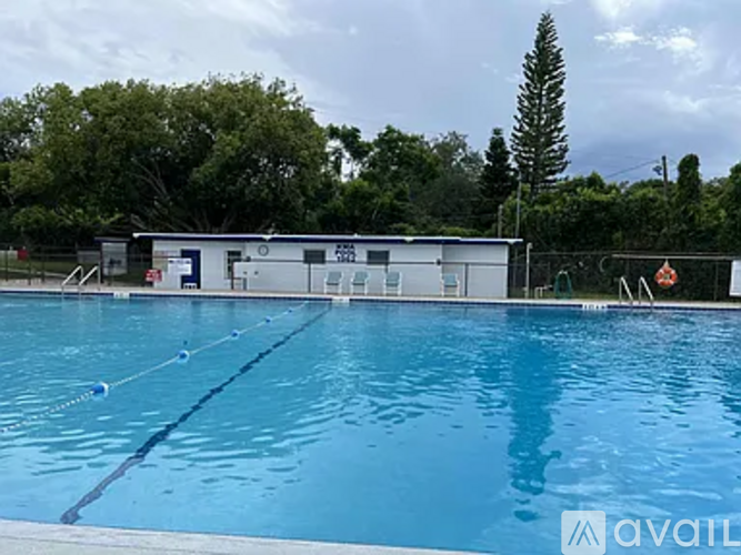 A swimming pool with a building in the background.