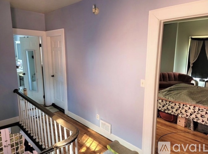 A bedroom with a bed and a mirror on the wall.
