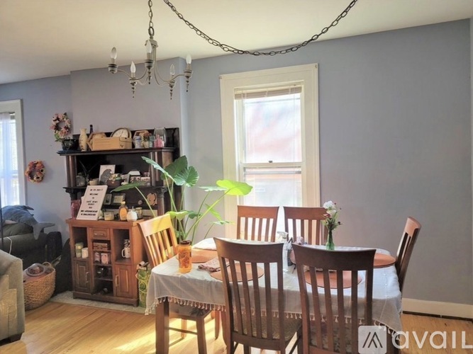 A dining room with a wooden table and chairs.