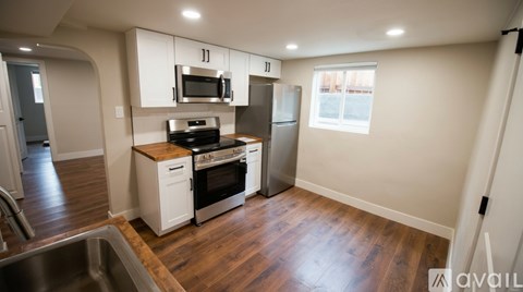 A kitchen with white cabinets and stainless steel appliances.