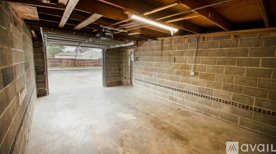 A spacious garage with a concrete floor and brick walls.