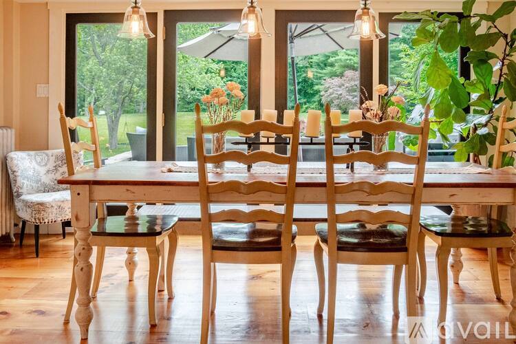 A dining room with a table set for six.