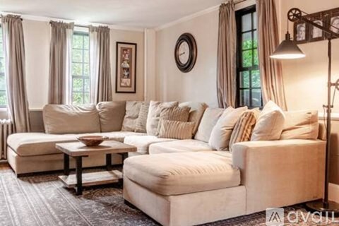A living room with a large sectional sofa and a coffee table.
