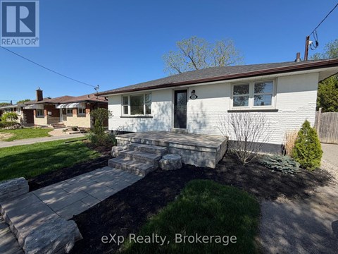 A house with a stone walkway leading to the front door.