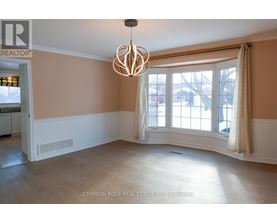 A large empty room with a chandelier hanging from the ceiling.