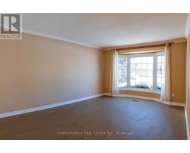 A room with a window and wooden flooring.
