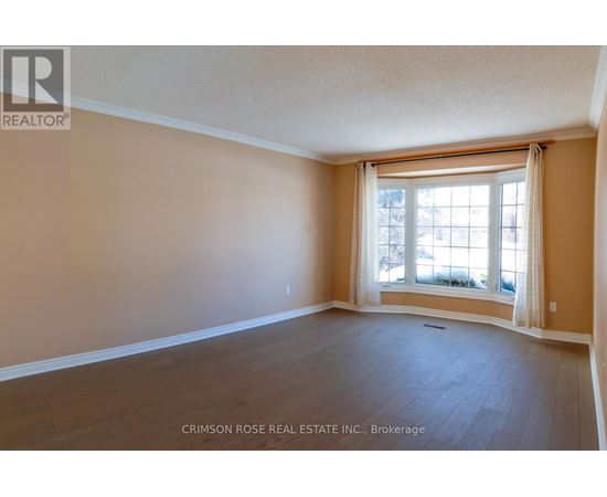 A room with a window and wooden flooring.