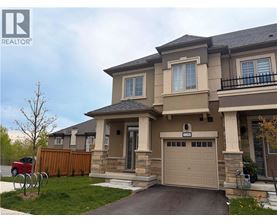 A two-story house with a garage and a driveway.