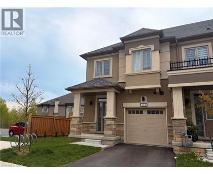 A two-story house with a garage and a driveway.
