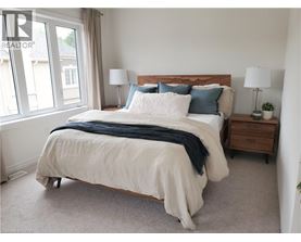 A bedroom with a large bed and a window.