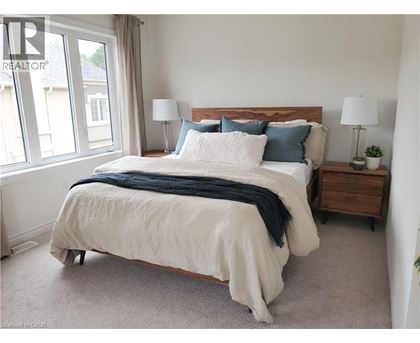 A bedroom with a large bed and a window.