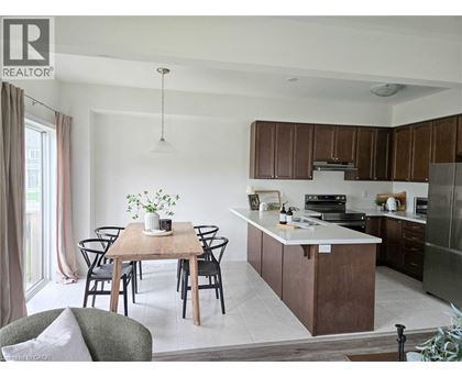 A modern kitchen with a dining table set for four.