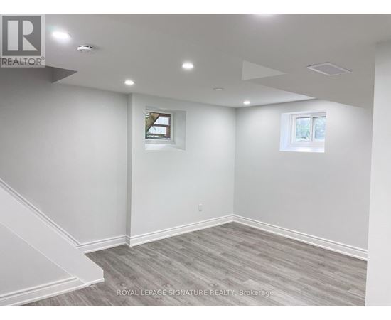 A room with a grey carpet and white walls.