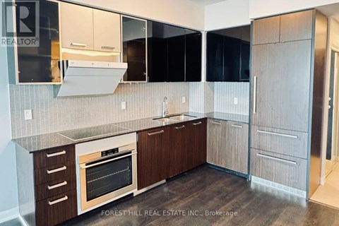 A kitchen with a wooden oven and cabinets.