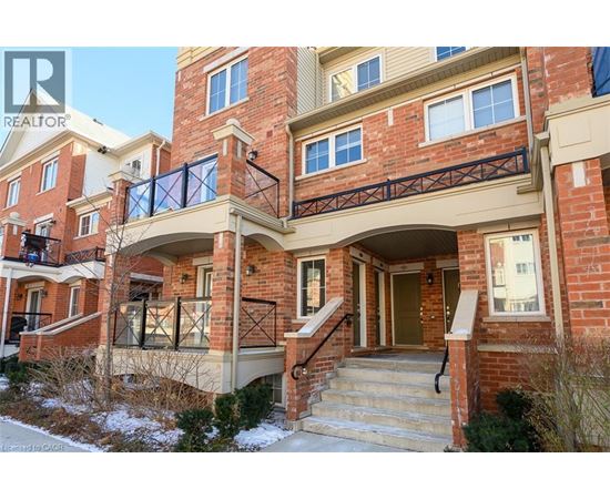 A red brick house with a balcony and a glass railing.