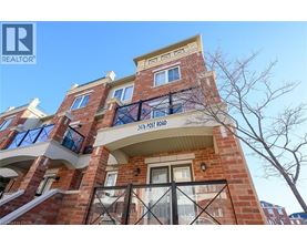 A red brick building with a balcony and a sign that reads "2176 FOSKO".