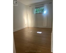A room with a window and a curtain.