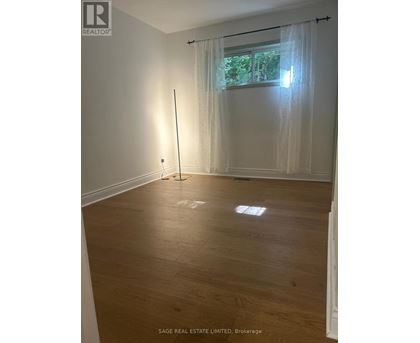 A room with a window and a curtain.