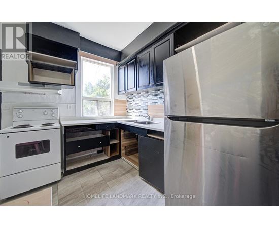 A modern kitchen with a white stove and black cabinets.
