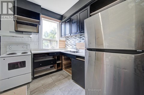 A modern kitchen with a white stove and black cabinets.