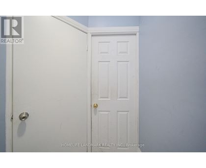 A white door with a gold handle is in a room with blue walls.