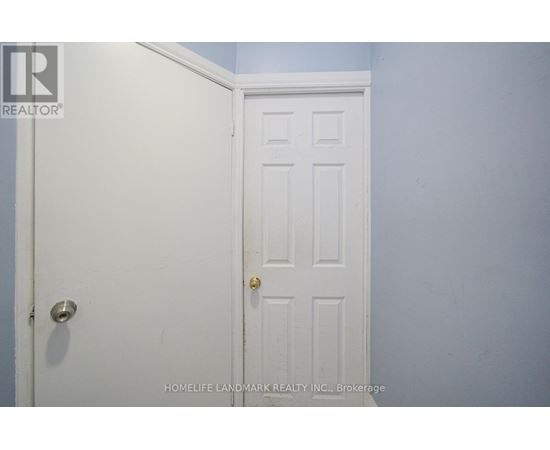 A white door with a gold handle is in a room with blue walls.