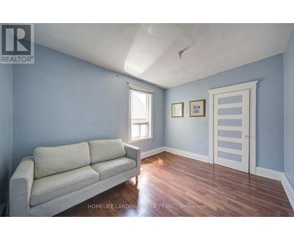 A living room with a couch and a door.