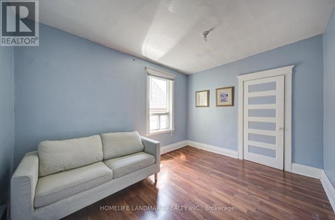 A living room with a couch and a door.