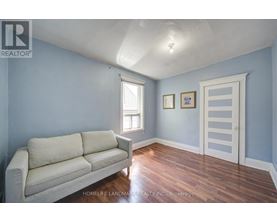 A living room with a couch and a door.