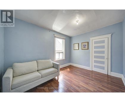 A living room with a couch and a door.
