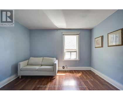 A living room with a couch and a window.
