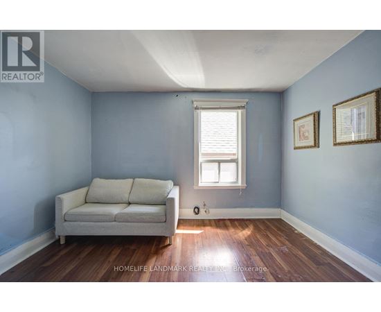 A living room with a couch and a window.