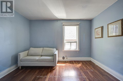A living room with a couch and a window.
