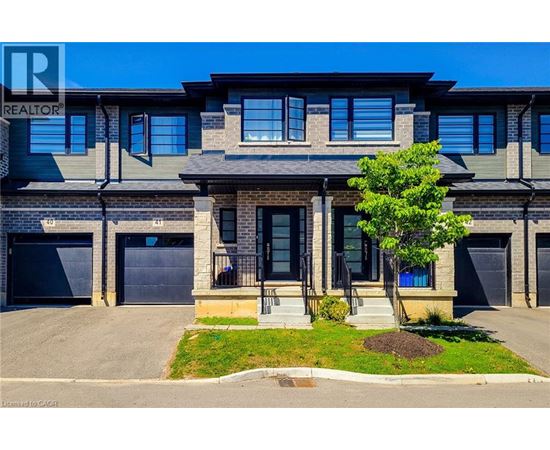 A modern two-story house with a garage on the left.
