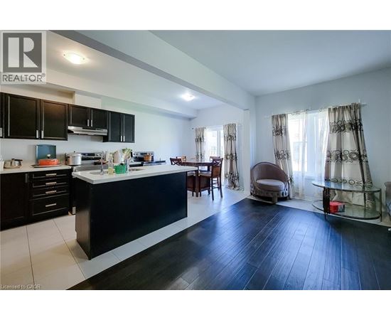 A modern kitchen with black cabinets and a black island.