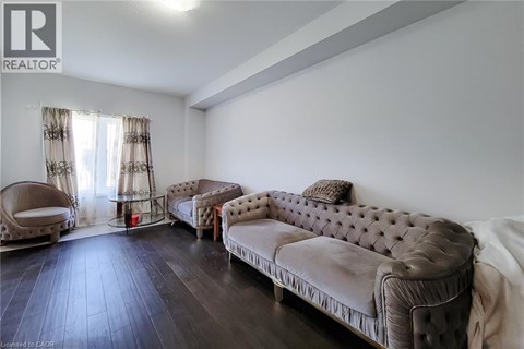 A living room with a brown sofa and a chair.