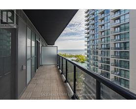 A balcony of a building with a glass door leading to the outside.