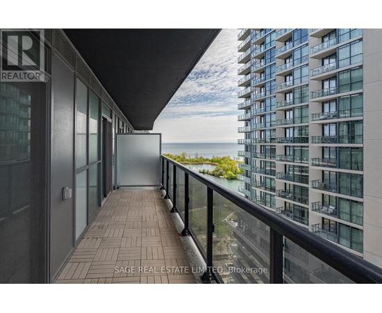 A balcony of a building with a glass door leading to the outside.