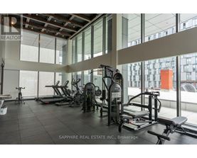 A gym with a variety of equipment including treadmills, weights, and exercise machines.