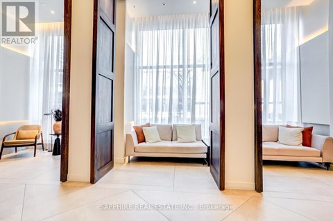 A living room with a white couch and a wooden floor.
