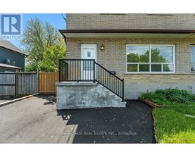 A house with a white door and a black railing.