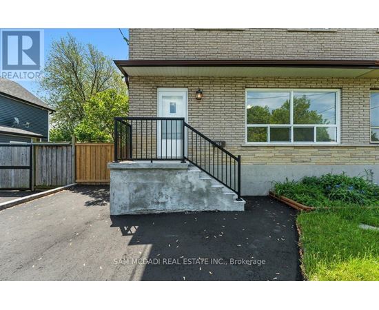 A house with a white door and a black railing.