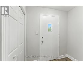 A white door with a small picture of a tree on it.