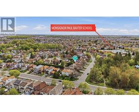 An aerial view of a residential area with a label pointing to Monsignor Paul Baxter School.
