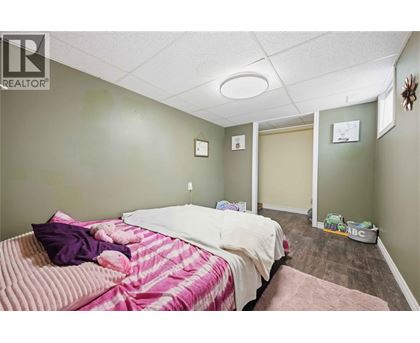 A bedroom with a bed and a teddy bear on it.