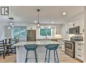 A modern kitchen with white cabinets and a central island.