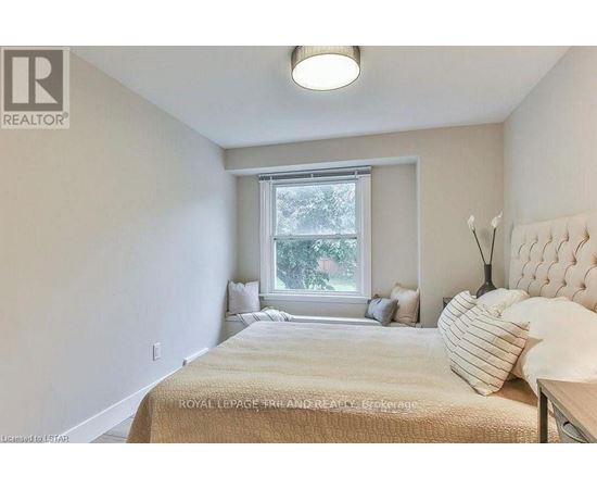 A bedroom with a large bed and a window.