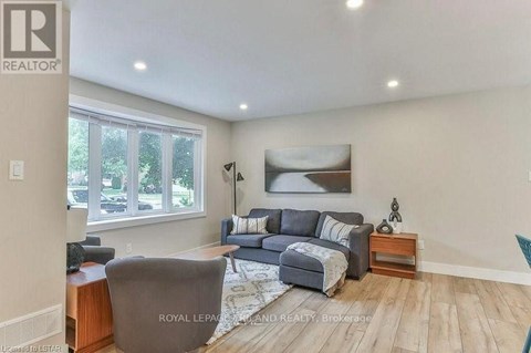 A living room with a grey couch and a wooden side table.